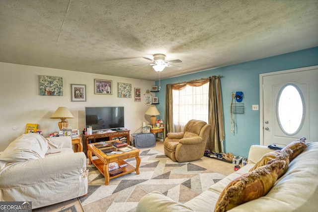 carpeted living room with ceiling fan and a textured ceiling