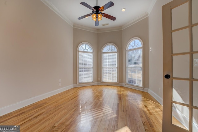 spare room with crown molding, ceiling fan, and light hardwood / wood-style floors