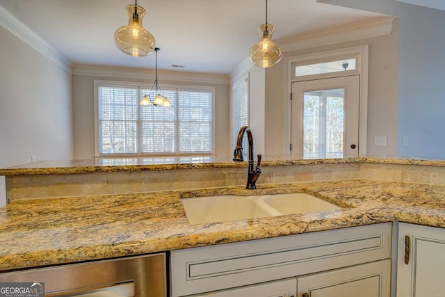 room details featuring hanging light fixtures, ornamental molding, sink, and light stone counters