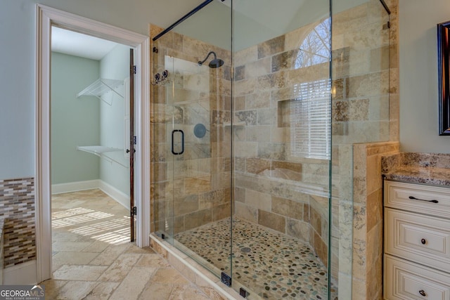 bathroom featuring vanity and a shower with door