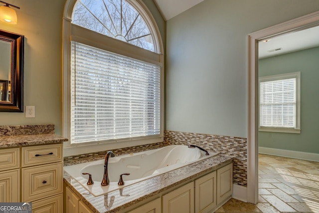 bathroom featuring vanity and a bath