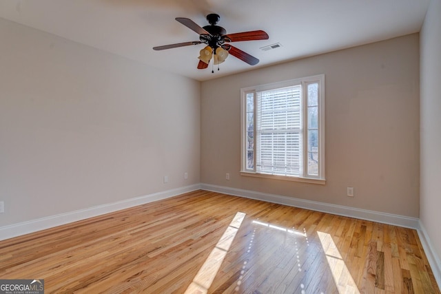 empty room featuring ceiling fan and light wood-type flooring