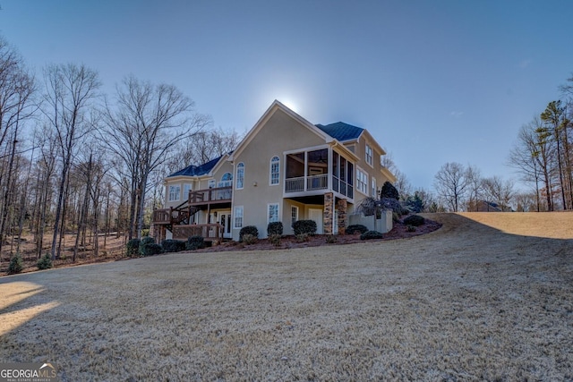 view of front facade with a front yard and a deck