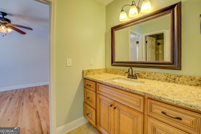 bathroom with vanity, hardwood / wood-style floors, and ceiling fan