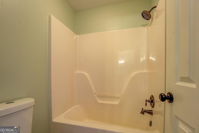 bathroom with shower / washtub combination and toilet