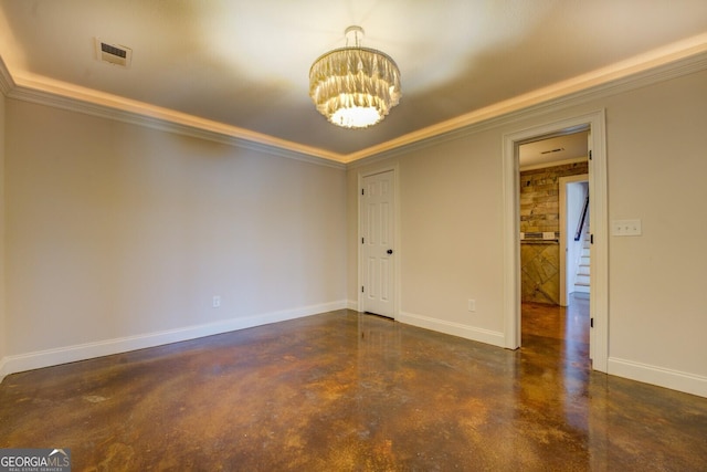 empty room featuring crown molding and a chandelier