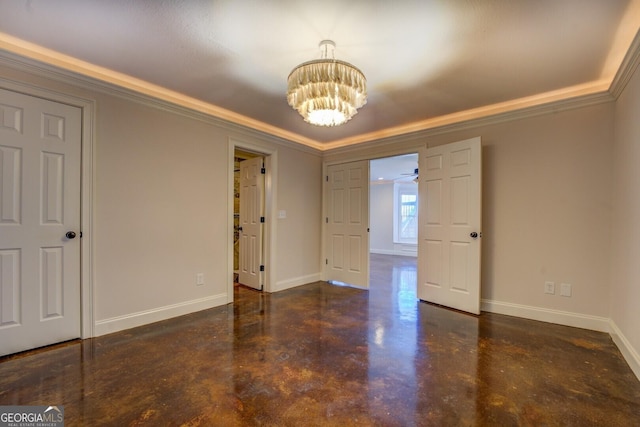 unfurnished room featuring ornamental molding and an inviting chandelier