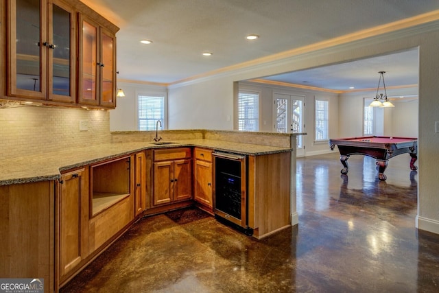 kitchen featuring wine cooler, a wealth of natural light, and kitchen peninsula