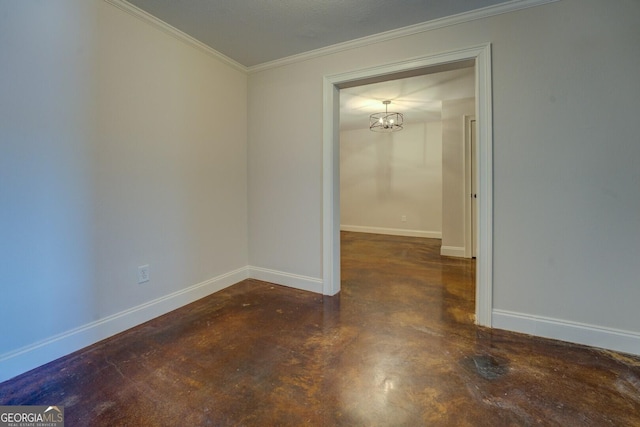 spare room featuring crown molding and a notable chandelier