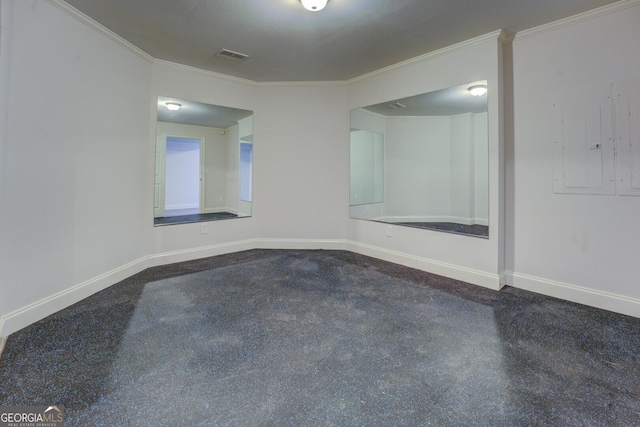 empty room featuring crown molding, carpet flooring, and electric panel