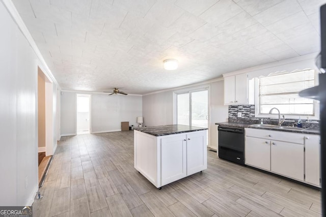 kitchen with white cabinets, sink, dishwasher, and a center island