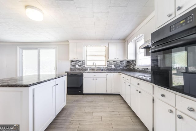 kitchen featuring tasteful backsplash, white cabinetry, sink, black appliances, and crown molding