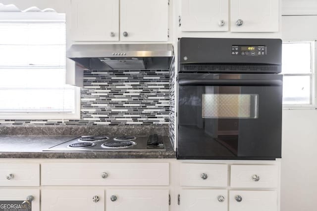 kitchen with white cabinetry, decorative backsplash, oven, and electric cooktop