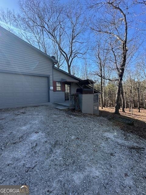 view of side of property featuring driveway and a garage
