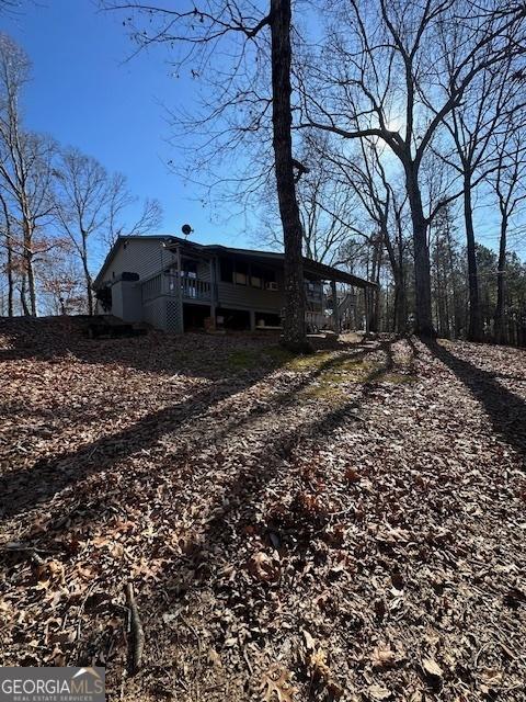 view of side of property featuring a wooden deck