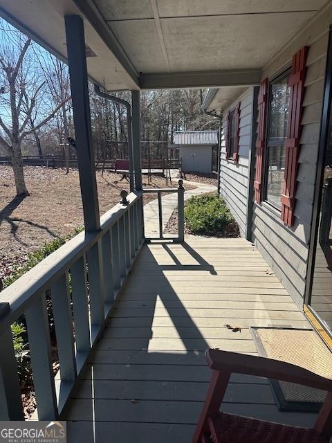 wooden terrace featuring an outbuilding