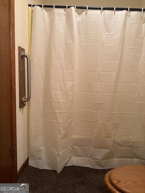 bathroom with a shower with curtain