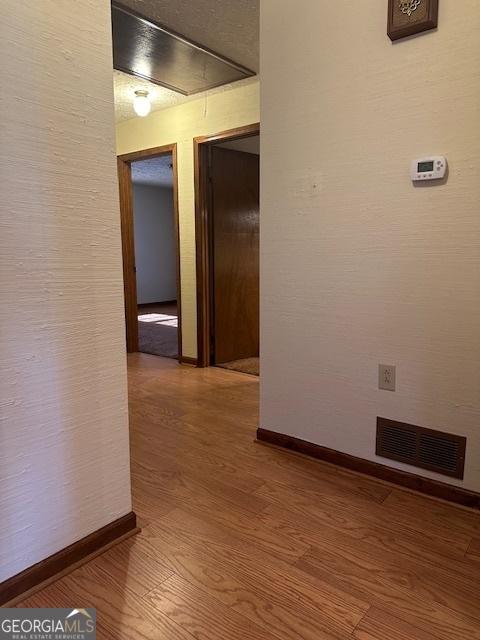 hallway featuring wood-type flooring