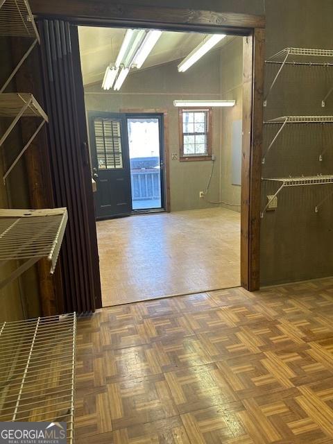 foyer featuring lofted ceiling and parquet floors