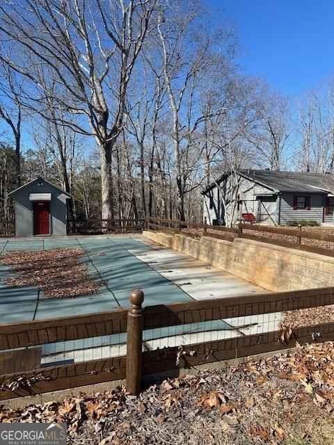 view of pool featuring an outbuilding