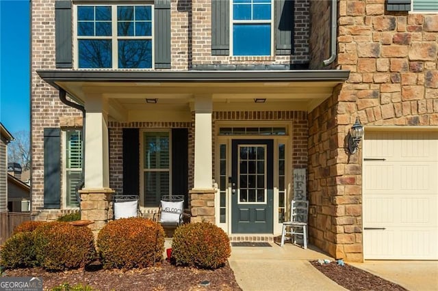 property entrance with a garage and covered porch