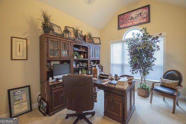 office area featuring vaulted ceiling and light carpet