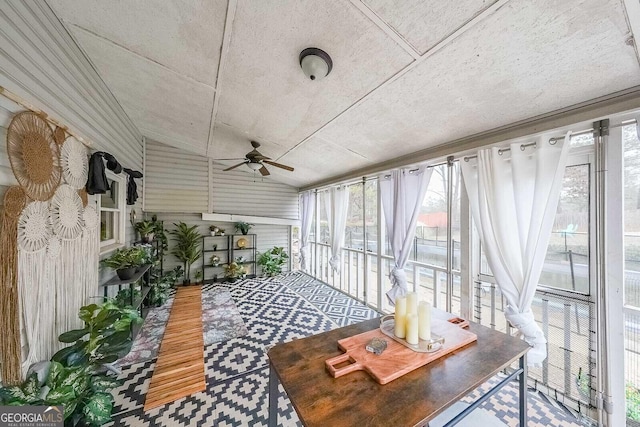 sunroom with ceiling fan and vaulted ceiling