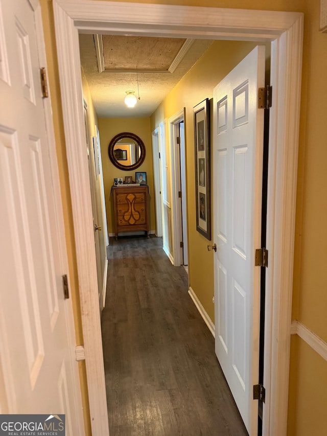 hall featuring dark hardwood / wood-style flooring and a textured ceiling