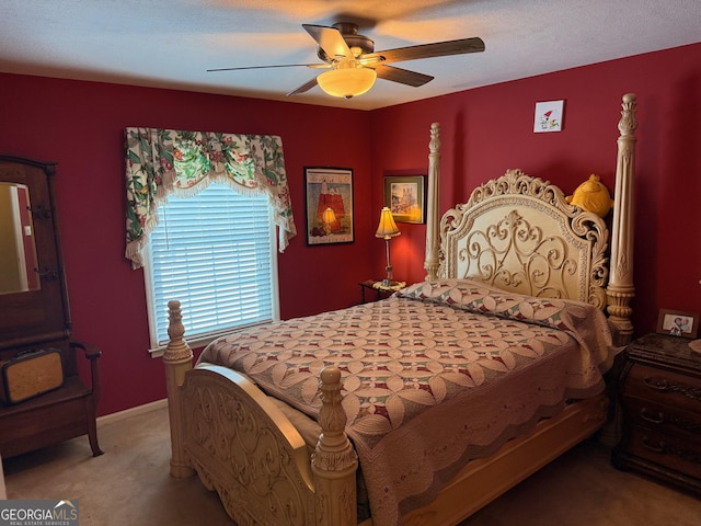 carpeted bedroom with a textured ceiling and ceiling fan