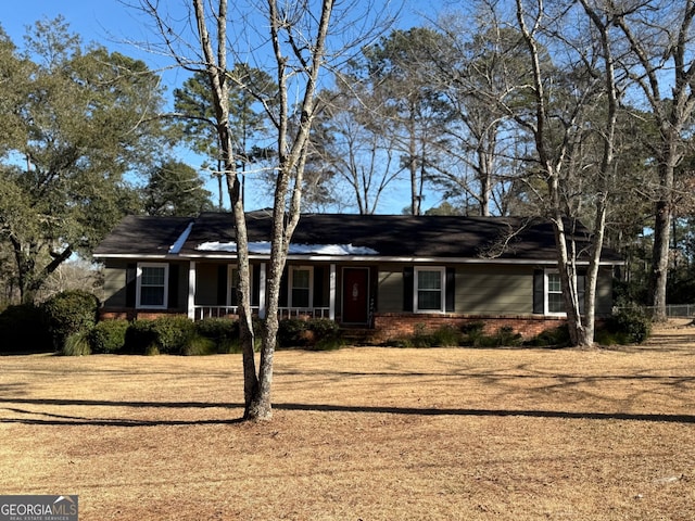 single story home featuring a front yard and covered porch