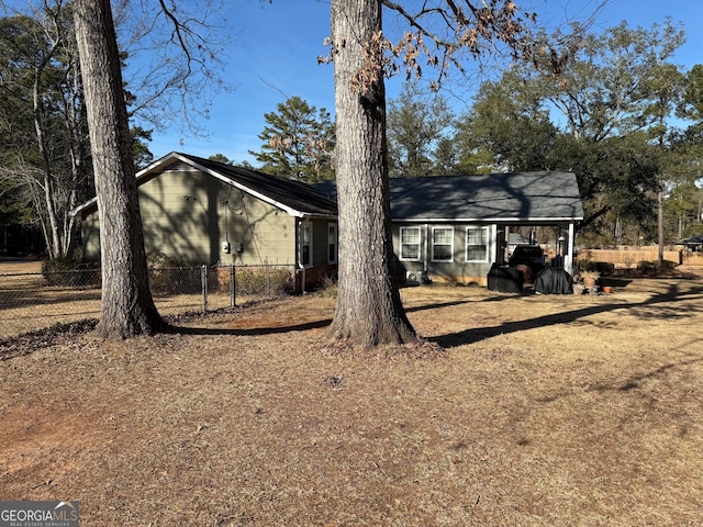 back of property with a carport