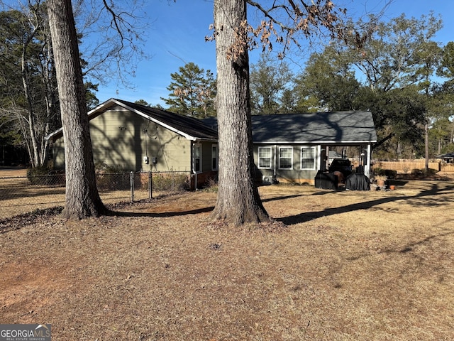 128 Byron Plantation Rd, Albany, GA 31721 - view of front of house featuring an attached carport and fence