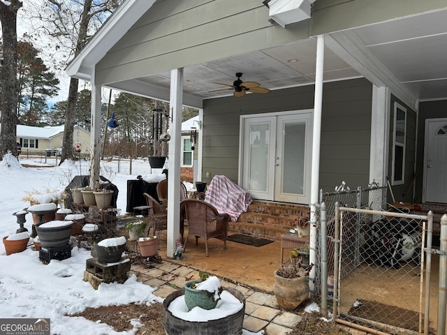 snow covered patio featuring ceiling fan