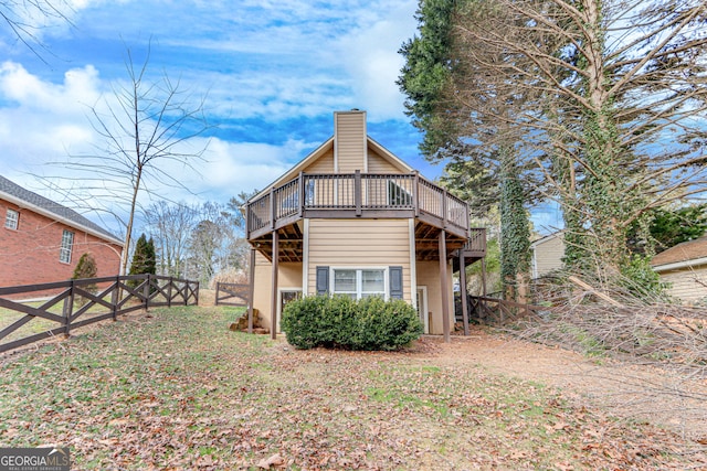 rear view of property featuring a wooden deck