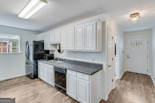 kitchen featuring white cabinetry, appliances with stainless steel finishes, sink, and decorative backsplash