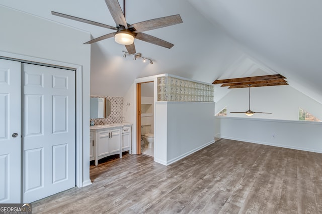 additional living space with ceiling fan, light hardwood / wood-style floors, and vaulted ceiling