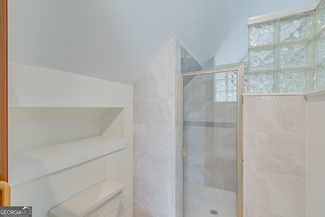 bathroom featuring vaulted ceiling and walk in shower