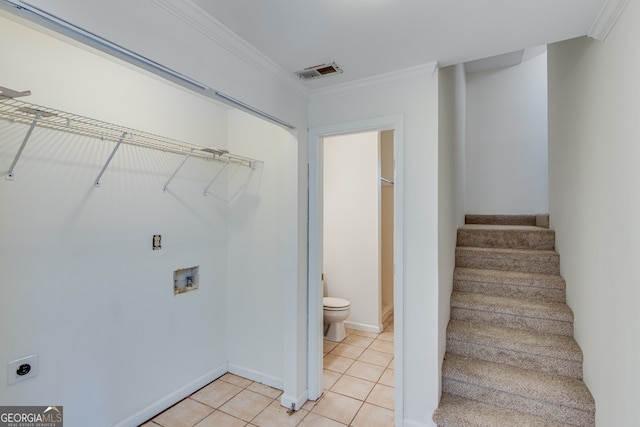 laundry area featuring ornamental molding, washer hookup, electric dryer hookup, and light tile patterned floors