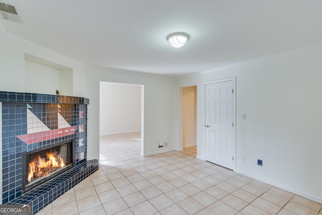 living room with light tile patterned floors, crown molding, and a tile fireplace