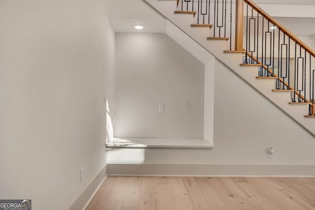 staircase featuring wood-type flooring