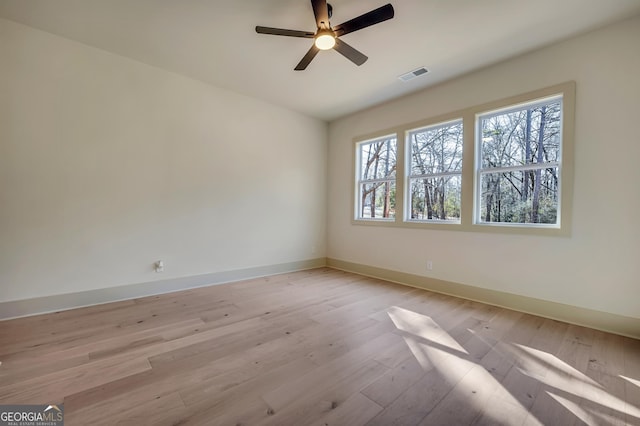 spare room with ceiling fan and light wood-type flooring