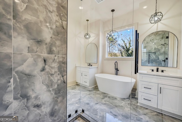 bathroom featuring vanity and a tub to relax in