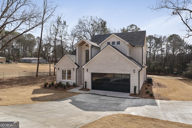 view of front property featuring a garage and central air condition unit