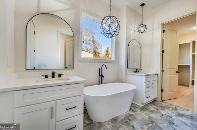 bathroom with vanity and a bath