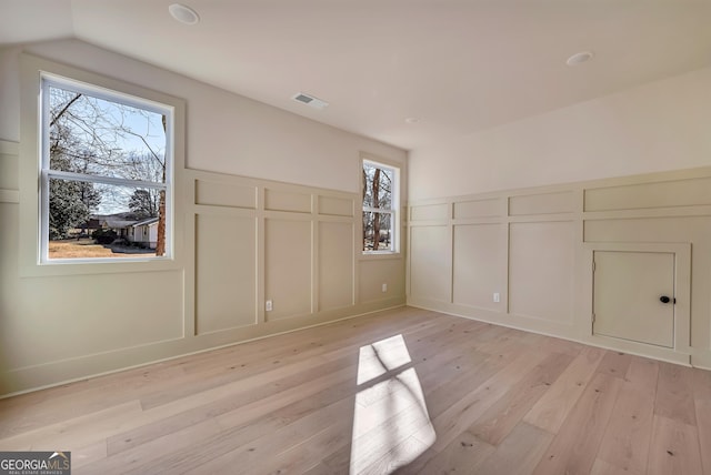 additional living space featuring light hardwood / wood-style flooring