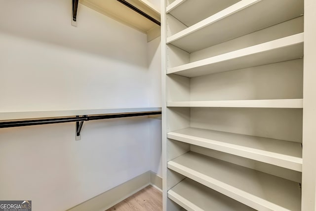 spacious closet with light hardwood / wood-style flooring