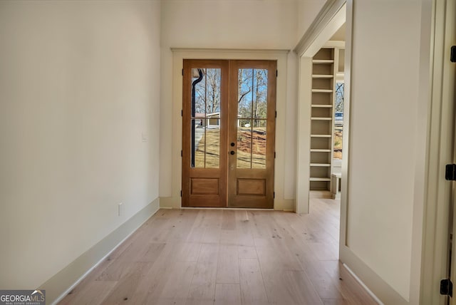 doorway to outside featuring french doors and light wood-type flooring