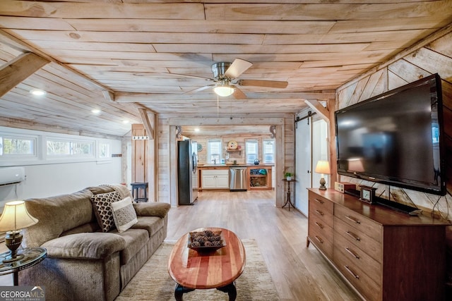 living room with wood walls, vaulted ceiling, wooden ceiling, ceiling fan, and light hardwood / wood-style floors