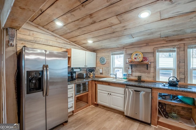 kitchen featuring lofted ceiling, light hardwood / wood-style flooring, appliances with stainless steel finishes, white cabinets, and wooden ceiling