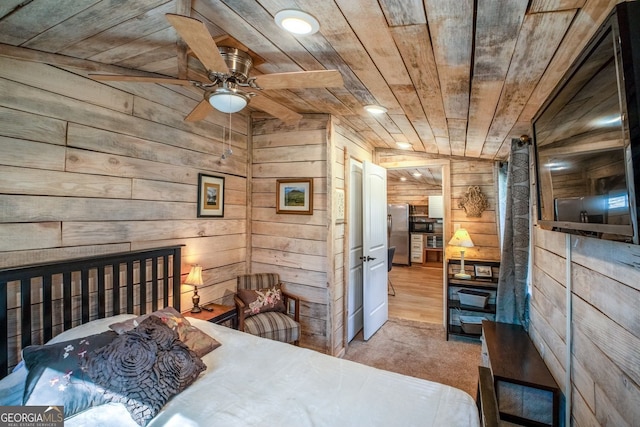 bedroom with light carpet, wooden ceiling, stainless steel refrigerator, and wood walls